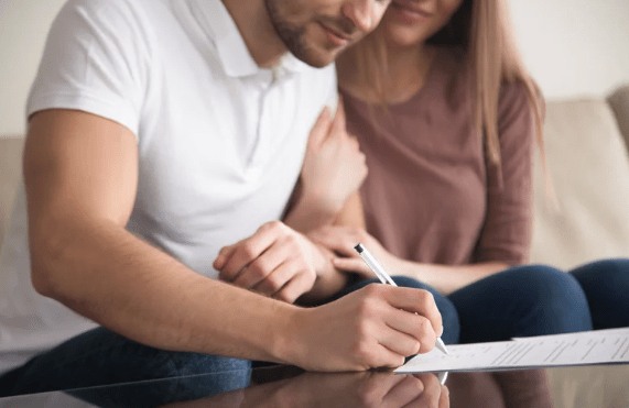 A couple signing a legal document